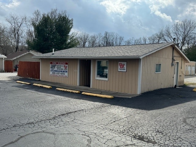 Beige building with white trim and PGT trucking sign